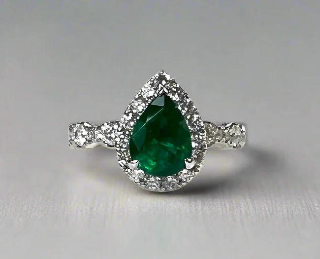 Halo - Style Women's Diamond Rings with a Center Diamond Surrounded by Smaller Diamonds in 18K GoldVia 1.31 Carats Pear Cut Emerald Gemstone Ring in 18K White Gold By Mike Nekta NYC